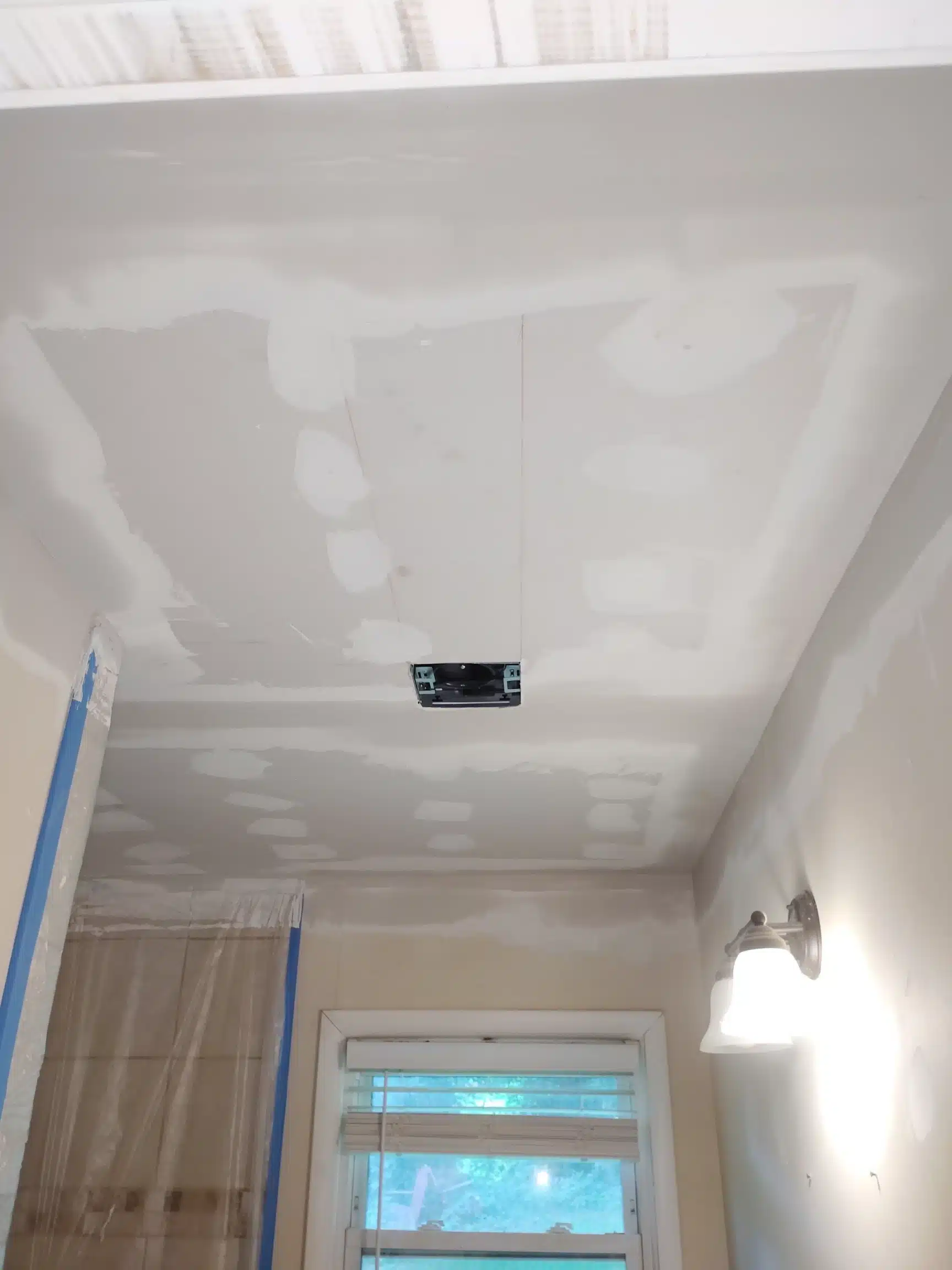 New ceiling drywall hung and taped once the structure was verified dry