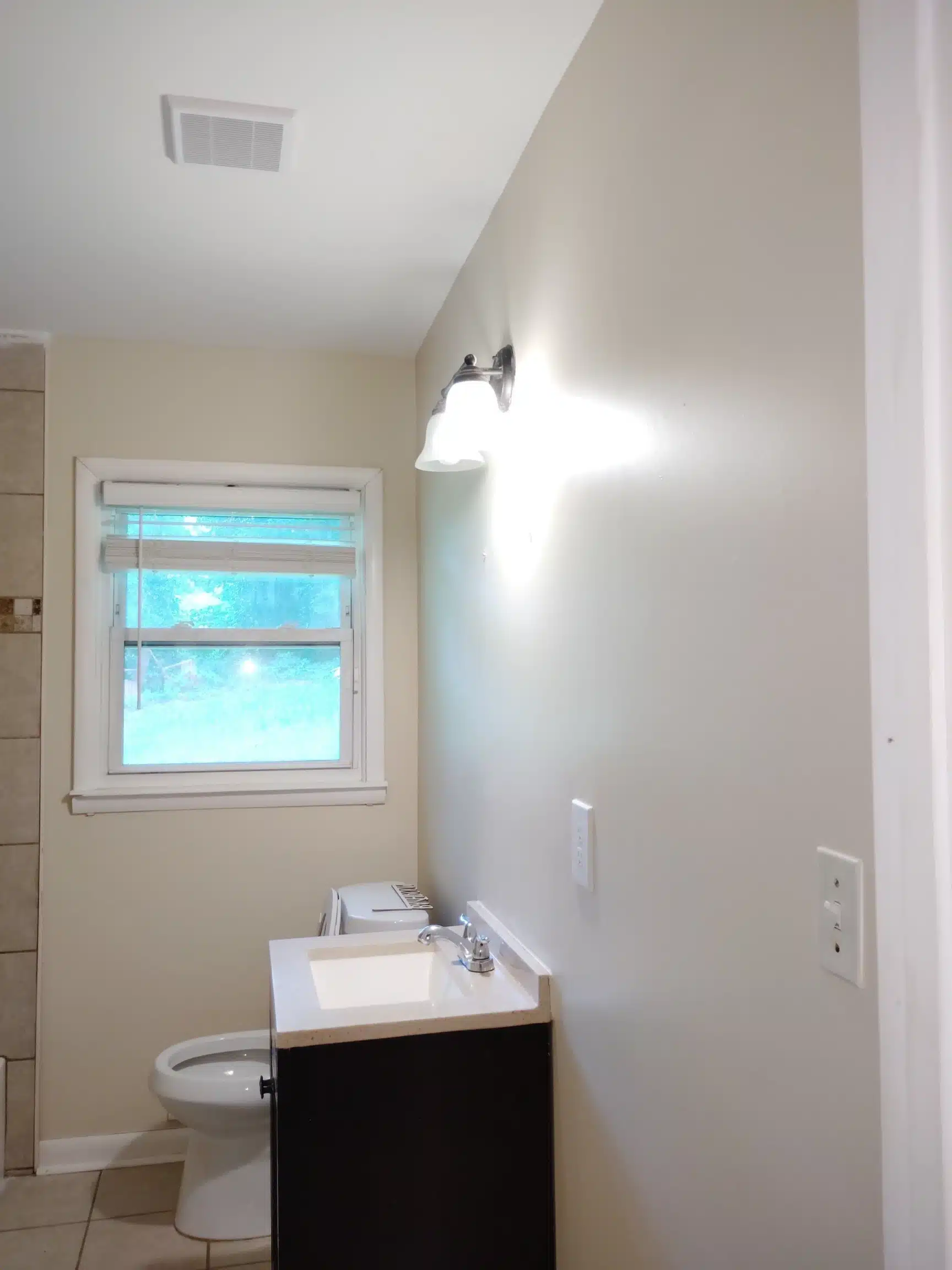 Restored bathroom after remediation, with new ceiling and wall finishes