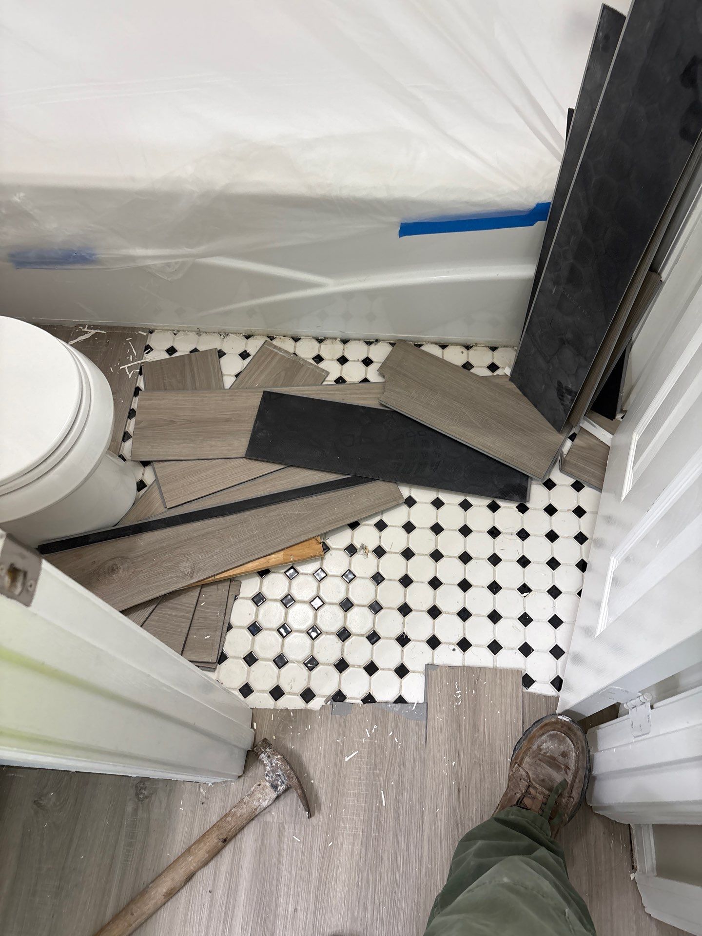 A soft spot and moisture damage in flooring above a slab leak