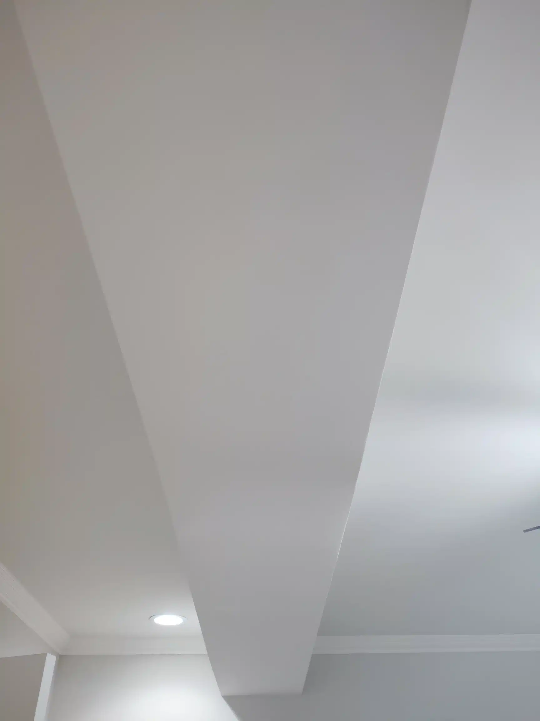 Basement ceiling and soffit run, following the path of the services in the floor above