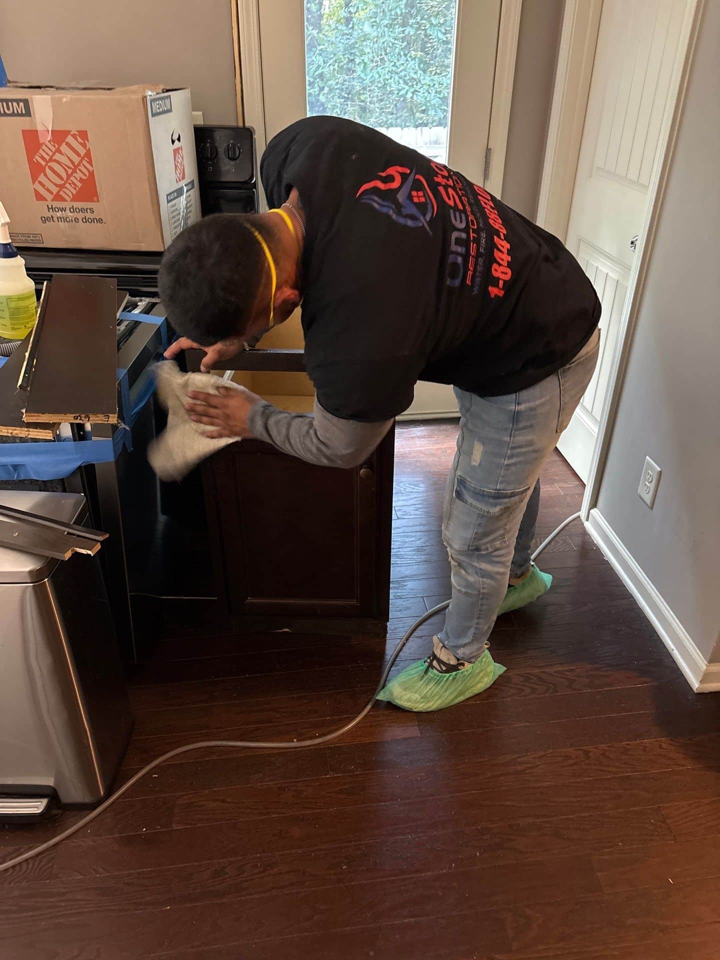 A One Stop Restoration technician setting up equipment on a metro-area extraction call