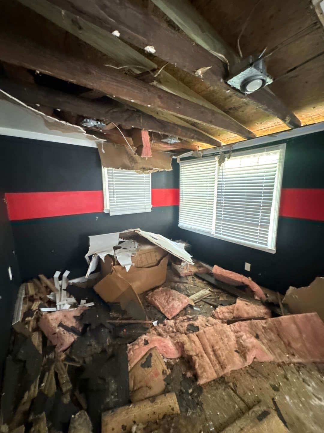 Original ceiling framing exposed in an older Atlanta home after fire and smoke damage