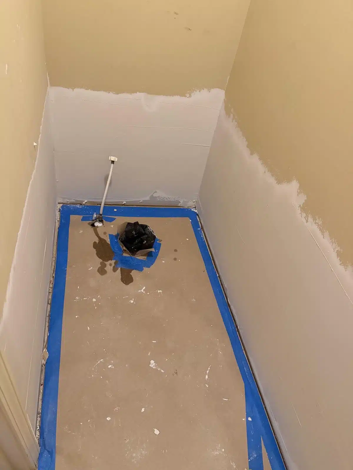 Second-floor bathroom stripped to the subfloor after the toilet supply leak