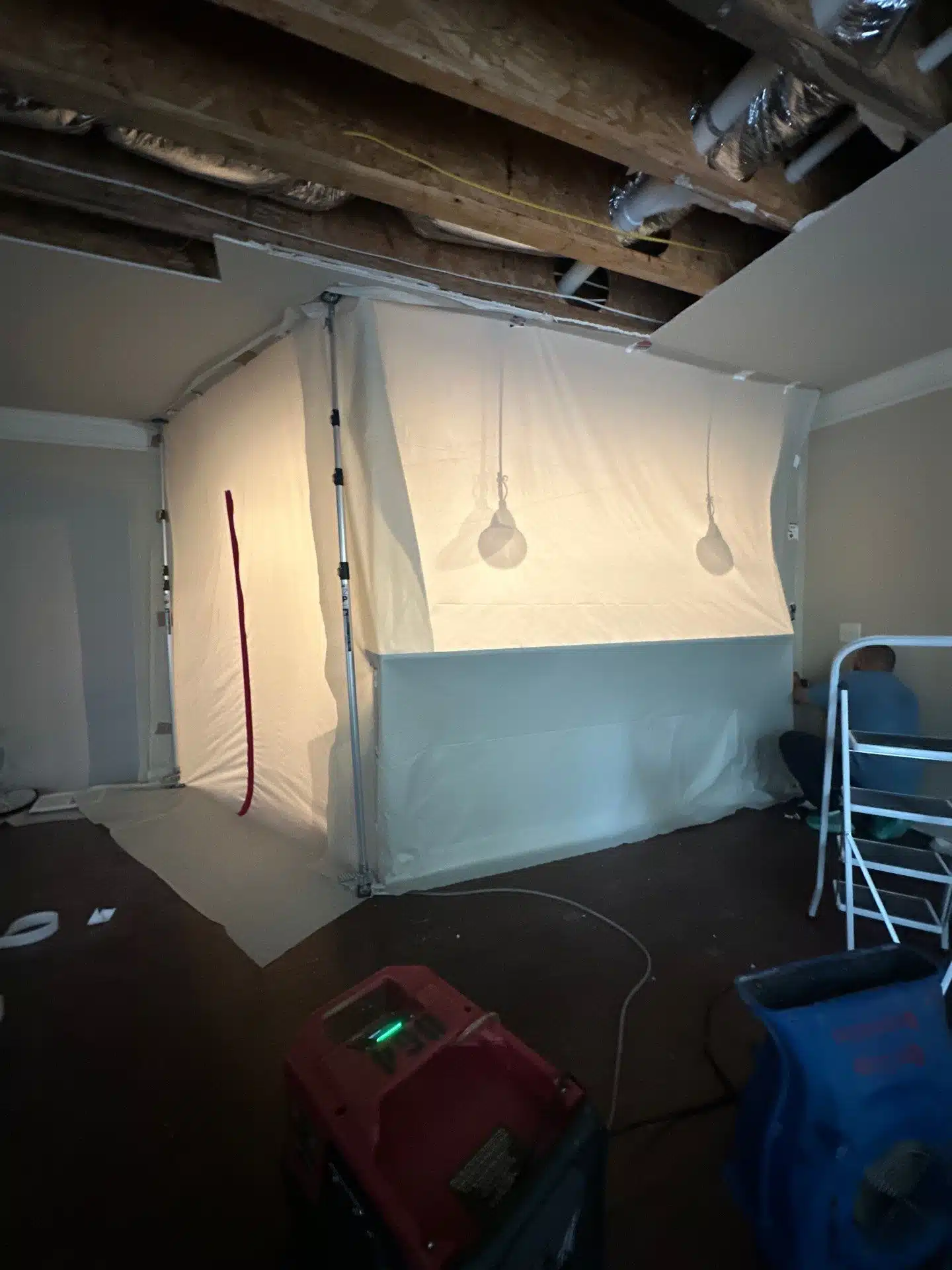 Containment sheeting and drying equipment set up in the affected lower level