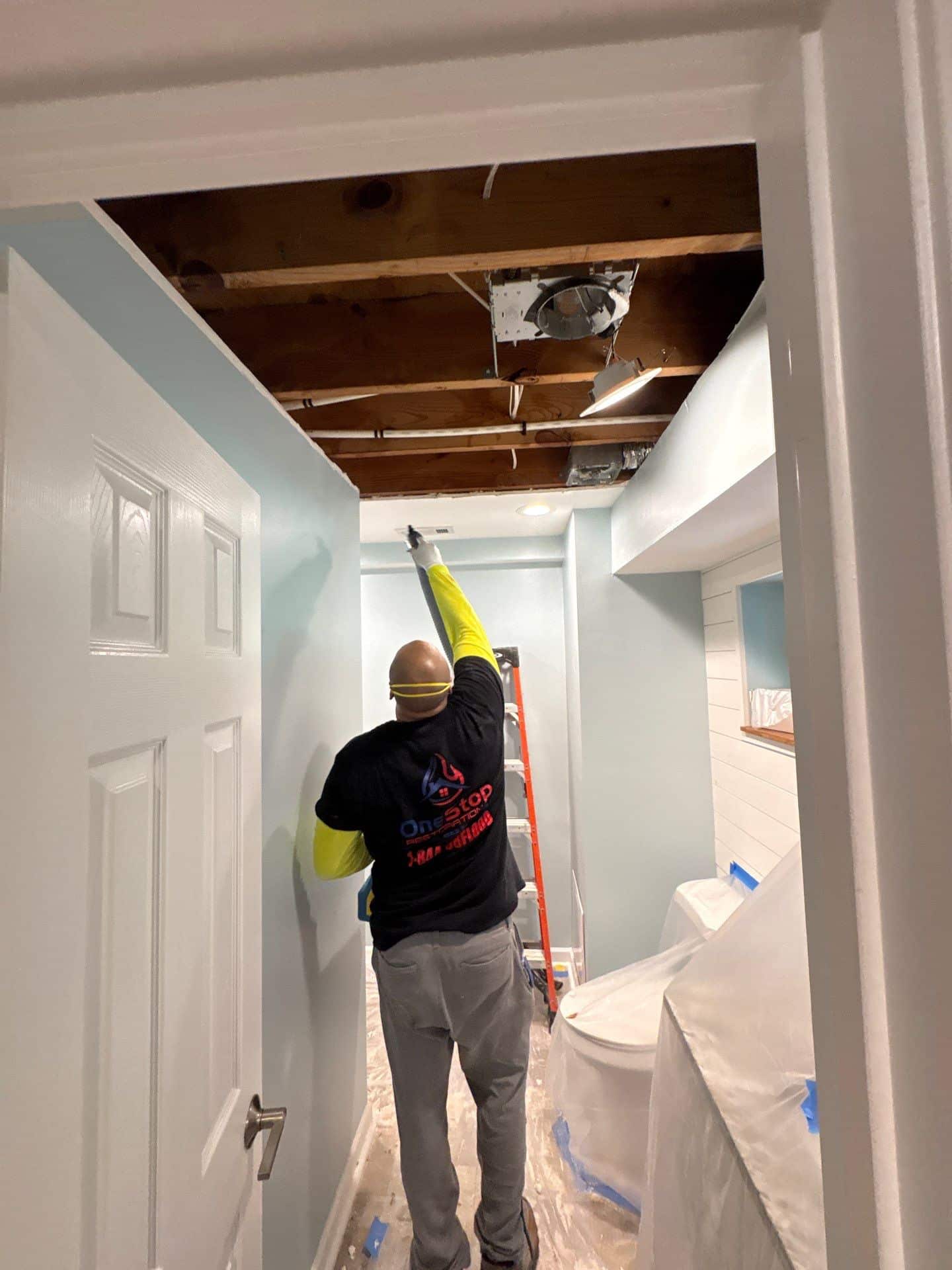 A hallway ceiling opened up to reach ductwork and framing during smoke damage restoration