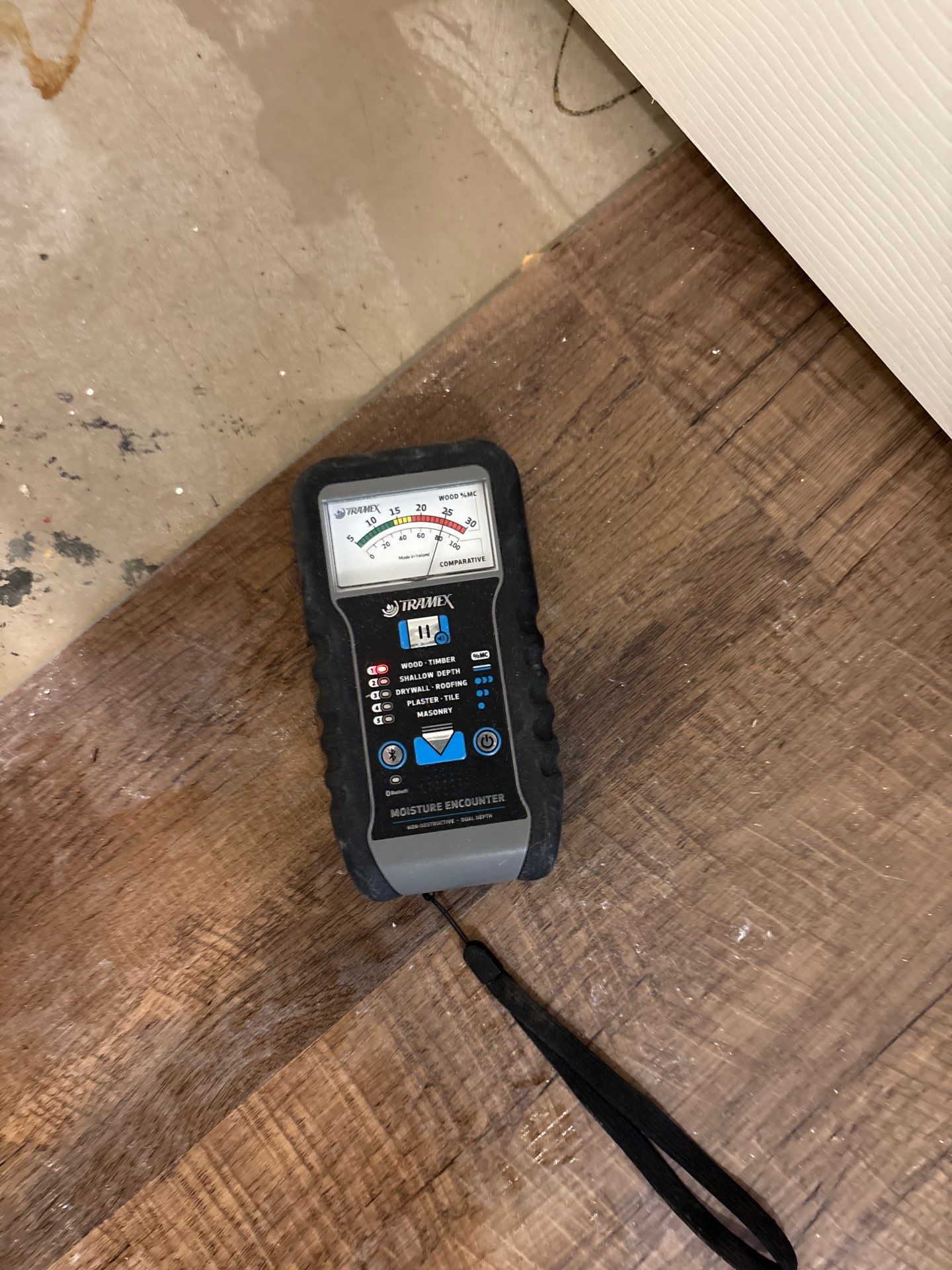 A moisture reading taken high on a wall stud, well above the visible damage
