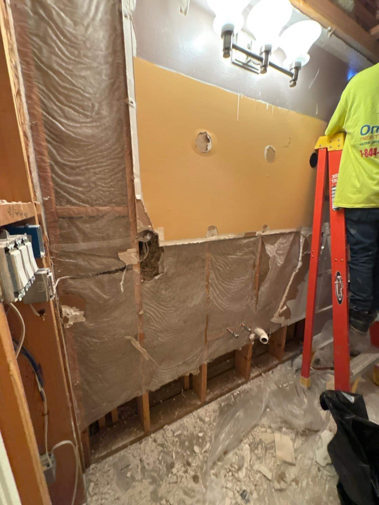 Moisture readings being taken in a commercial space before drying equipment is positioned