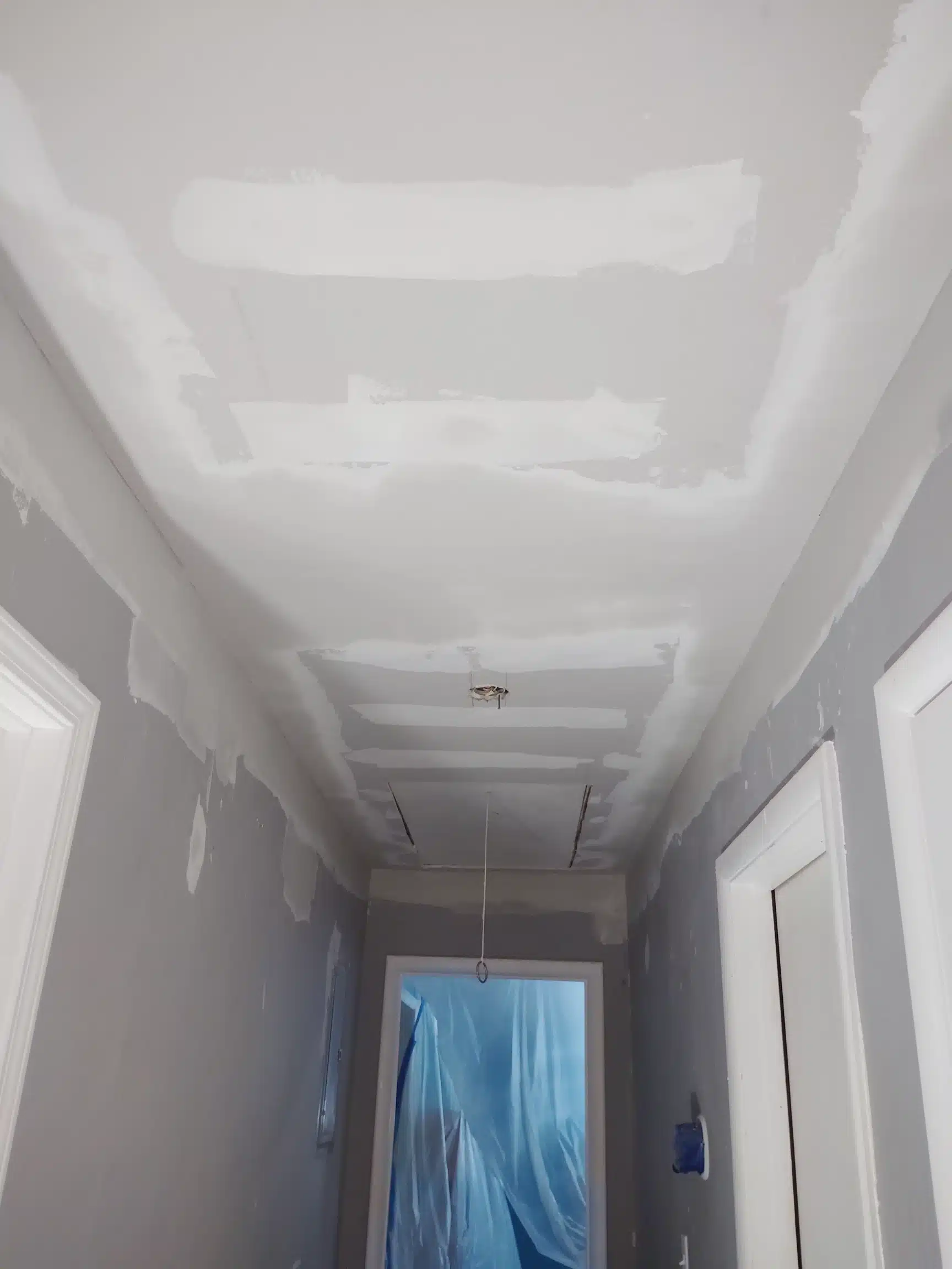 Finished and painted hallway ceiling with no visible patch line