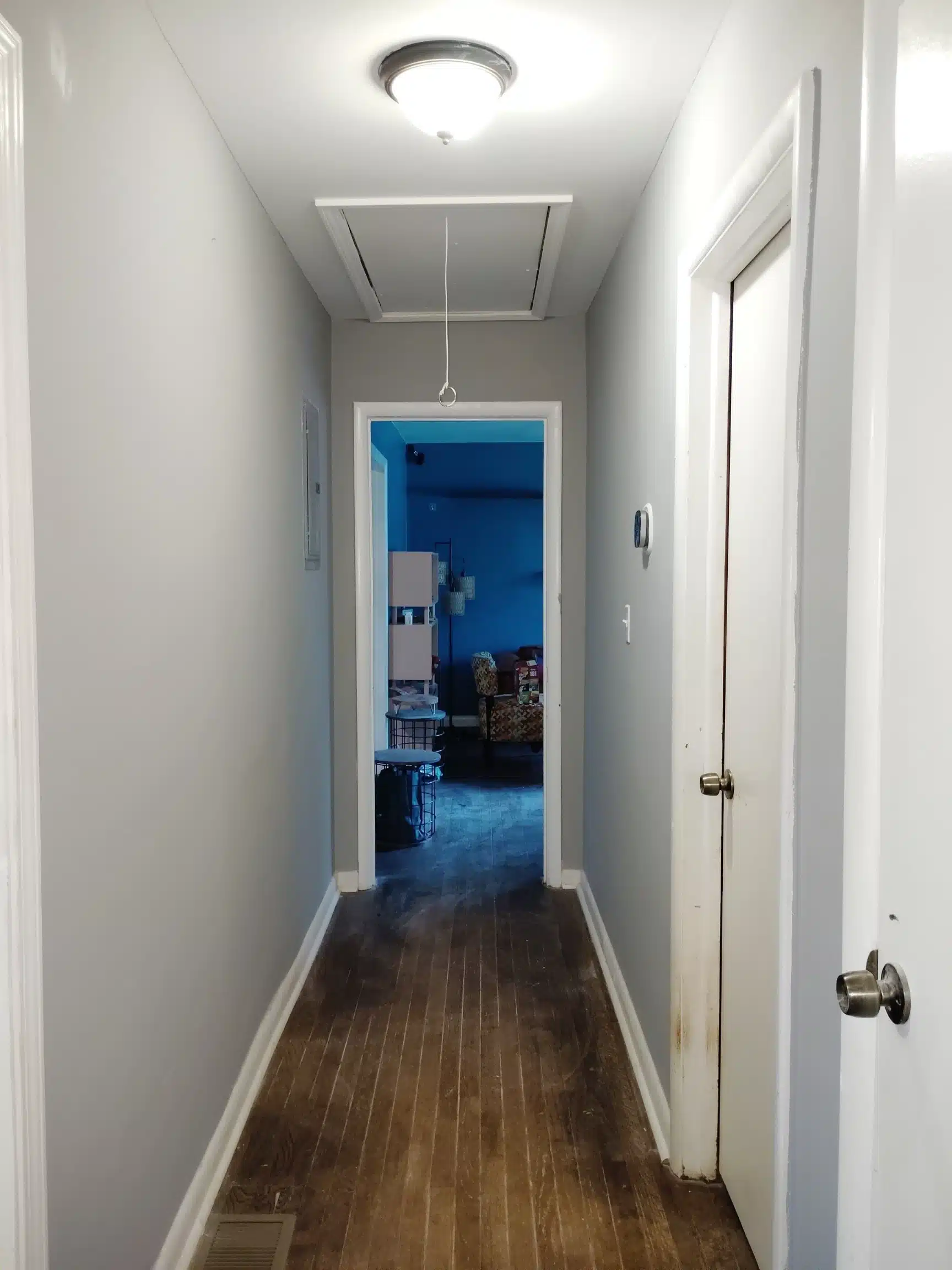 Hallway returned to pre-loss condition, looking through to the living area
