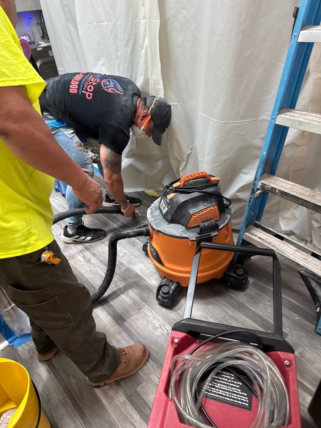 A One Stop Restoration technician running extraction equipment during a documented daily check-in