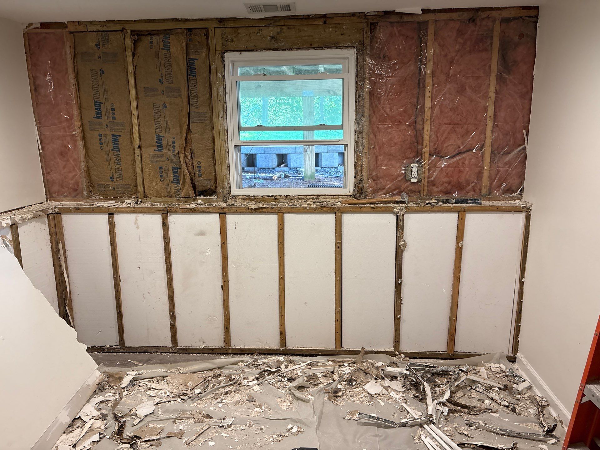 Air scrubbing equipment running inside an opened stud wall during mold remediation