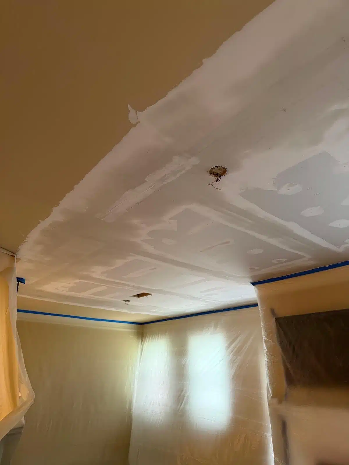 New ceiling drywall installed and finished after the structure was verified dry